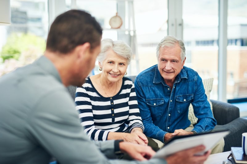 Shot of senior couple having a conversation with a technician at home.