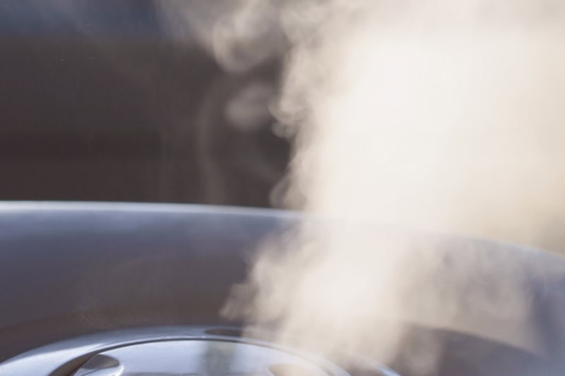 steam or mist rising from the top of a humidifier.